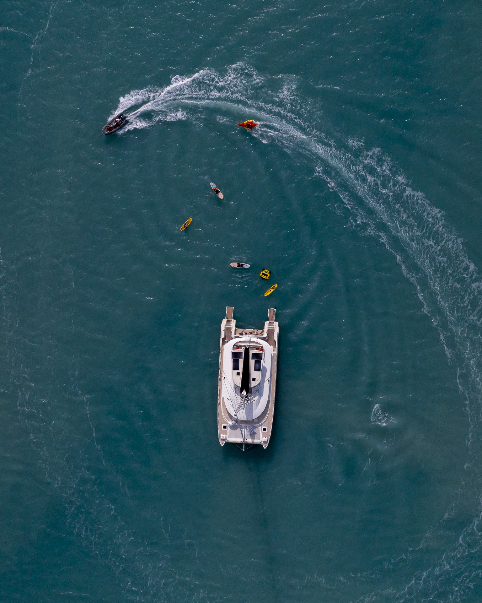 People enjoying watersports and jetski next to the Havanna in the Whitsundays