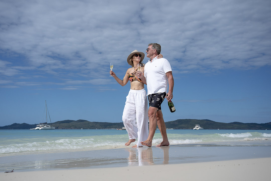 Couple enjoy a private walk along the beach with the Havanna int eh background